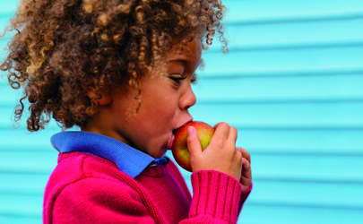 child eating fruit